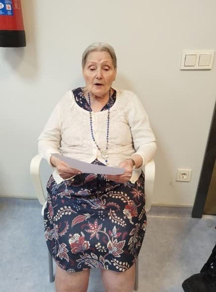 Una residente lee un manifiesto durante la celebración del "Día de los Abuelos"