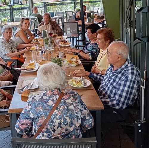 Mesa de residentes que prueban un plato de cachopo
