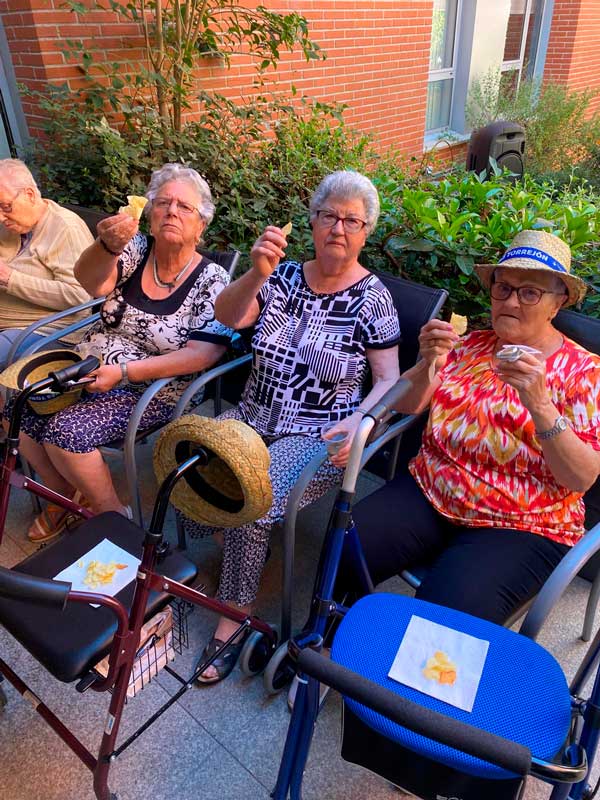 Residentes felices tomando un vermut en el jardín