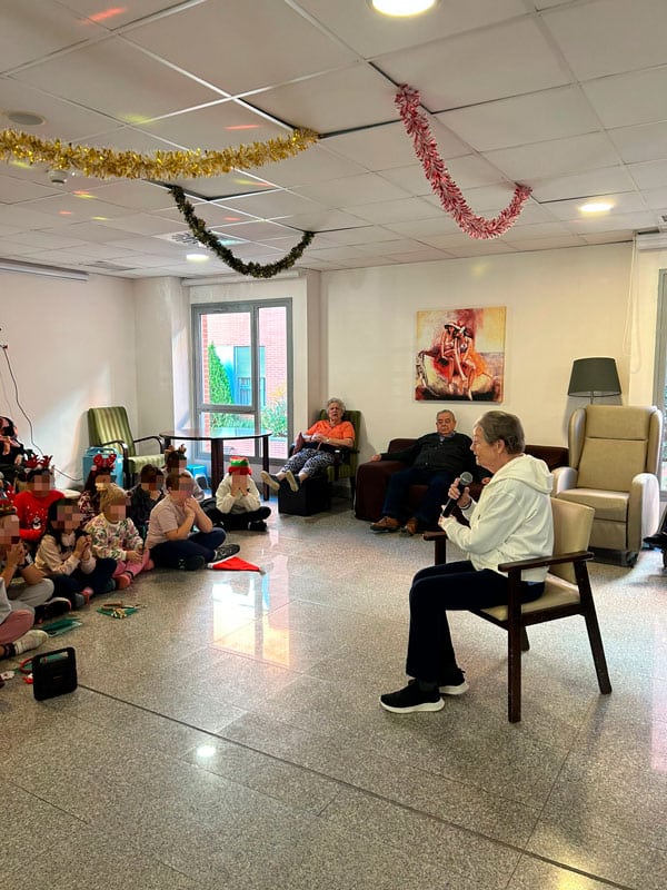 Una residente toca la guitarra a varios jóvenes