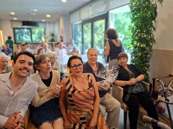 Ancianos disfrutando de una celebración de verano en MGS Seniors con música y alegría.